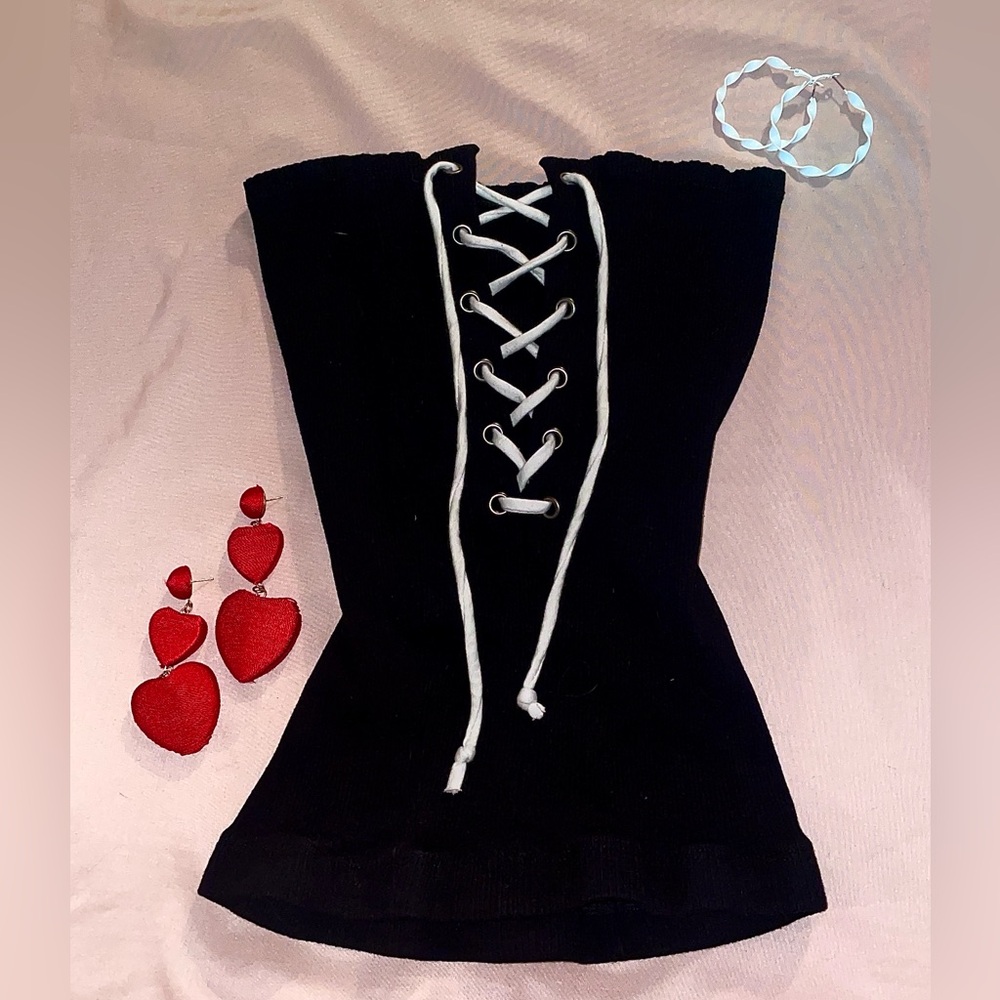 Black, corset like tube top. Strings to adjust size. Reversible. See details.